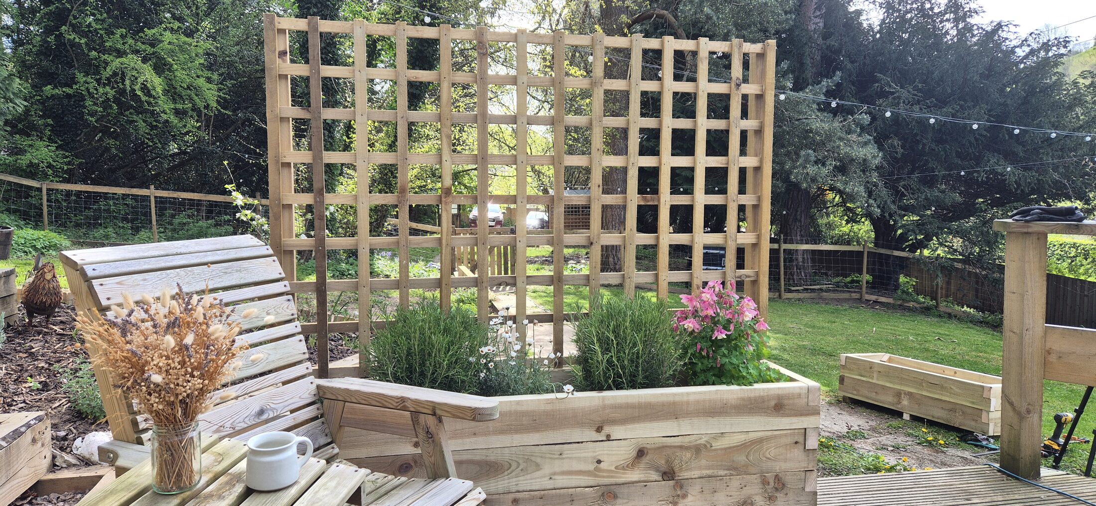 HEWN trellis privacy screen seen from below, against trees and sky